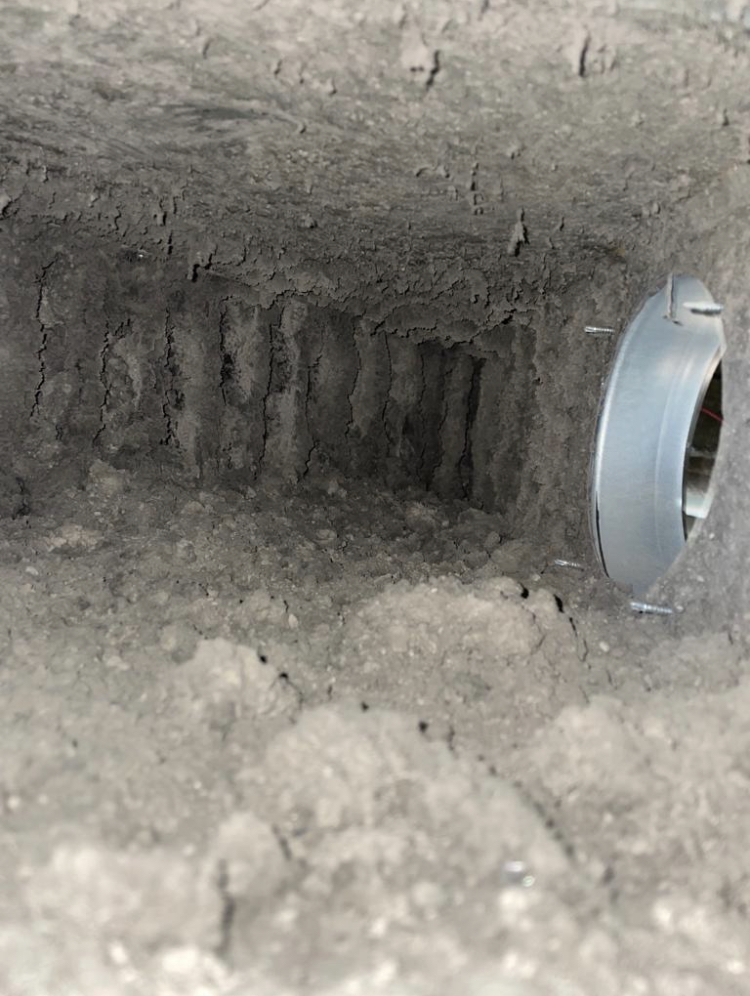 Lint and deposit build-up inside laundry extract ductwork before cleaning
