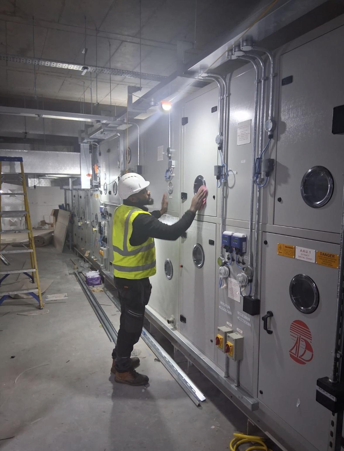 Deduct Ltd engineer carrying out commercial AHU and ventilation hygiene works in a UK plant room